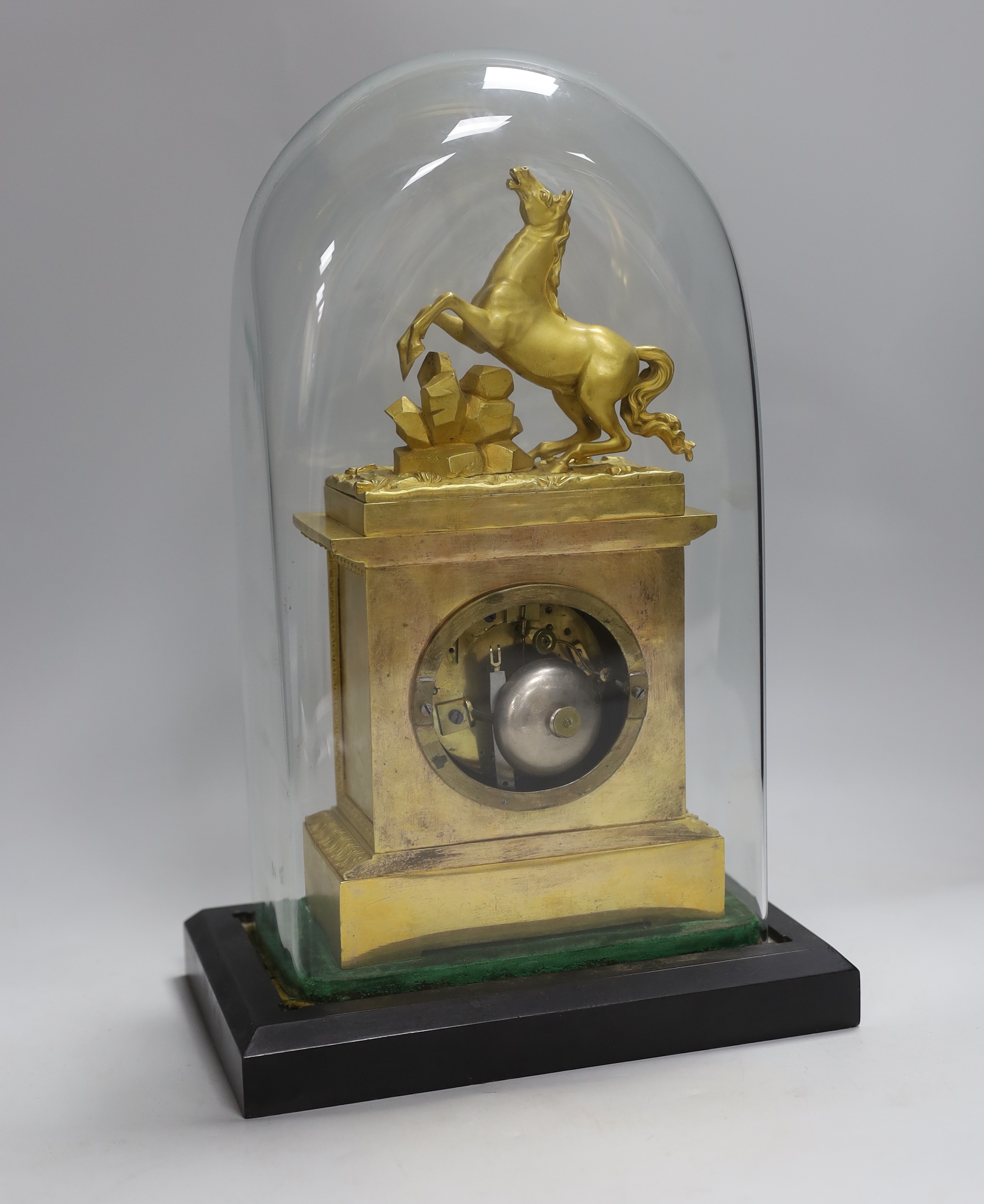 A French mid 19th century gilt mantel clock under dome, striking on a bell, 38 cm high